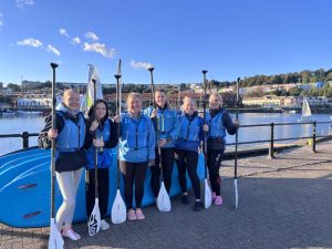 Women paddleboarding together during a paddleboarding hen do in Bristol Harbour
