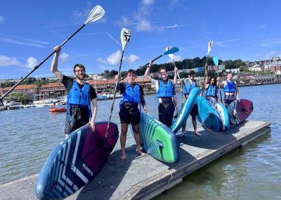 A group returns from adventure paddleboarding on Bristol Harbour