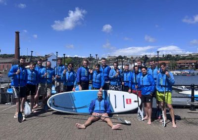 large stag do paddleboarding group about to depart on Bristol Harbour