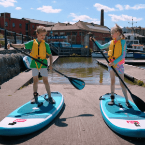 two children prepare to go paddleboarding on Bristol Harbour